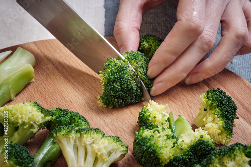 Cutting fresh broccoli with a knife