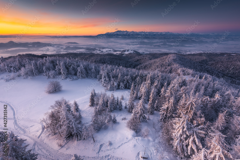 Winter morning in Gorce on the tower on the top of Lubań. A beautiful, romantic atmosphere with a view of the Pieniny Mountains, the Beskids and the Tatra Mountains.
