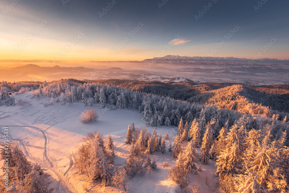 Winter morning in Gorce on the tower on the top of Lubań. A beautiful, romantic atmosphere with a view of the Pieniny Mountains, the Beskids and the Tatra Mountains.
