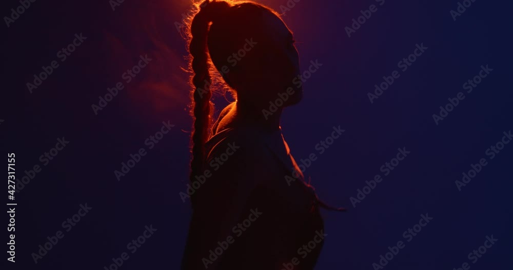Cool girl dancing hot passionate dance in spot light. Professional female performer, expression and rhythm