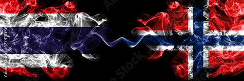 Thailand, Thai vs Norway, Norwegian smoky mystic flags placed side by side. Thick colored silky abstract smokes flags.