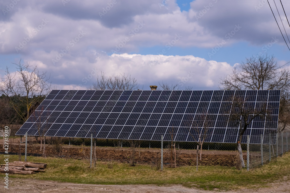 Solar panels in the countryside on a spring day with changeable weather. Solar panels in the countryside on a spring day with changeable weather.