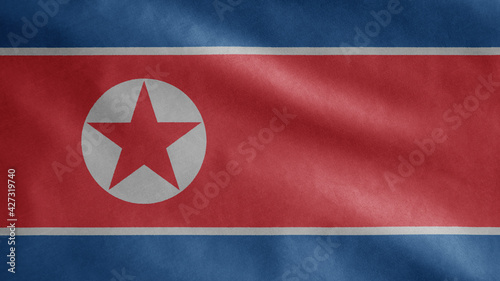North Korean flag waving in the wind. Close up of Korea banner blowing soft silk