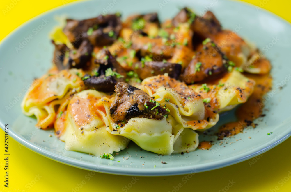 Fresh egg pasta with ricotta cheese and porcini mushrooms paste filling, delicious tortelloni Fresh egg pasta with ricotta cheese and porcini mushrooms paste filling, delicious tortelloni