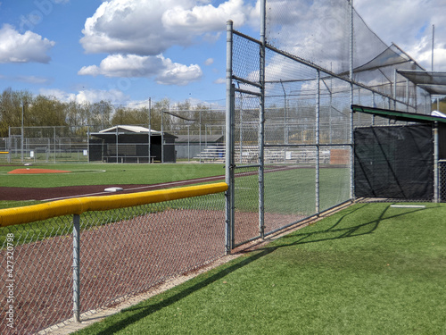 a large, empty baseball field on a bright, sunny day