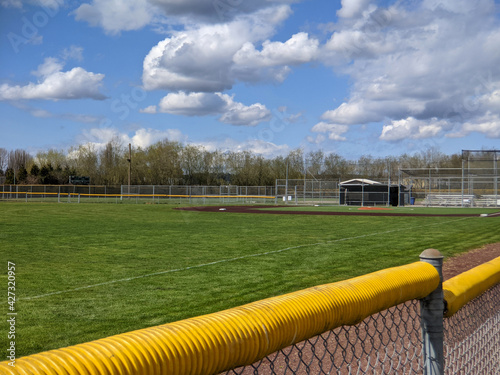 a large, empty baseball field on a bright, sunny day