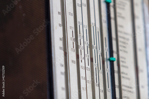 Close-up of a panel with radio frequencies and a green indicator. Narrow depth of field. photo