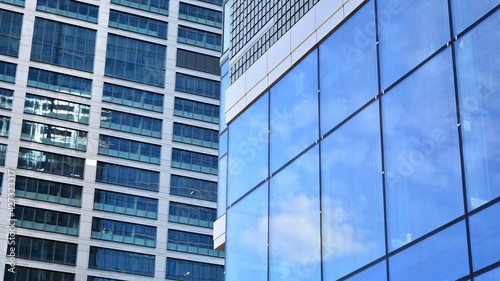 Glass clad facade of a modern building covered in reflective plate glass.