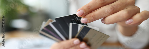 Konstfotografi Fan of plastic credit cards is in woman's hand.