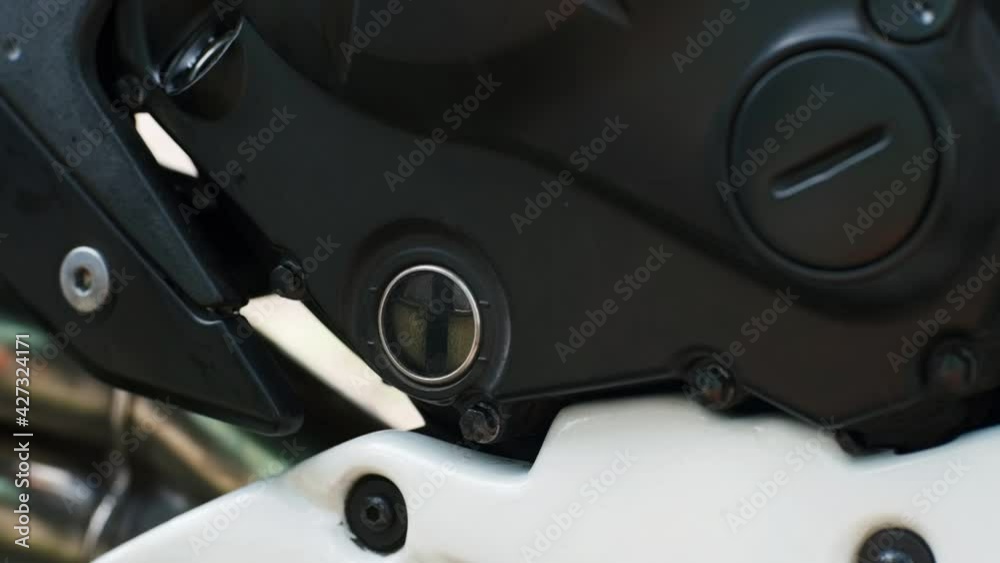 Engine oil level on motorcycle, engine oil change. Pouring oil to motorcycle engine Engine oil level on motorcycle, engine oil change. Pouring oil to motorcycle engine