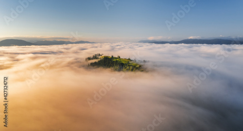 Mountains in clouds at sunr...