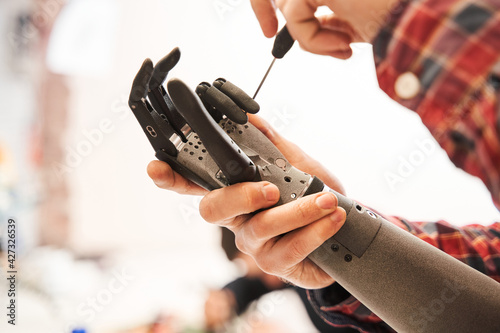 Εκτύπωση καμβά Man scientist twisting with screwdriver contacts in mechanical plastic hand