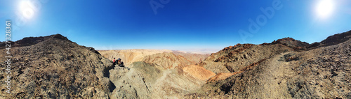 hiking trail in Eilat mountains. Red rock formations and boulders. Panoramic view over the trail on surrounding red mountains. Eilat, Israel Israel, Eilat Mountains: Red Canyon