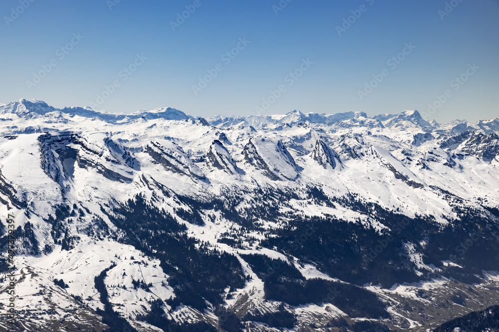 mountain landscape, the seven churfirsten in snowy winter, photographed from the säntis, by day, in bright sunshine without clouds