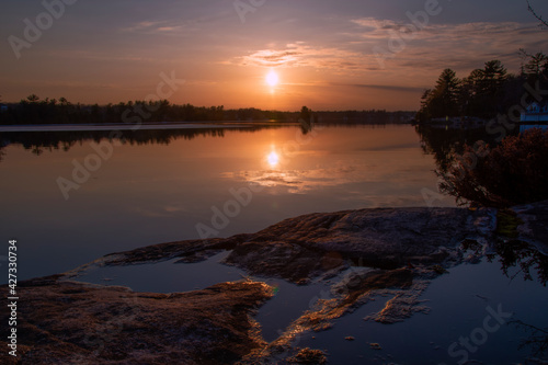 An early spring sunset over Lake Muskoka in the small cottage town of Gravenhurst, Ontario, reflecting in the water.