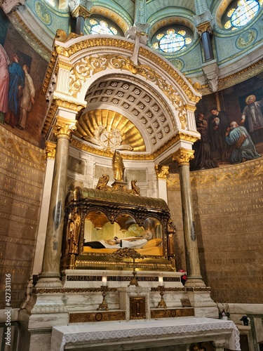 The body of Saint John Mary Vianney, entombed above the main altar in the Basilica at Ars, France.  photo