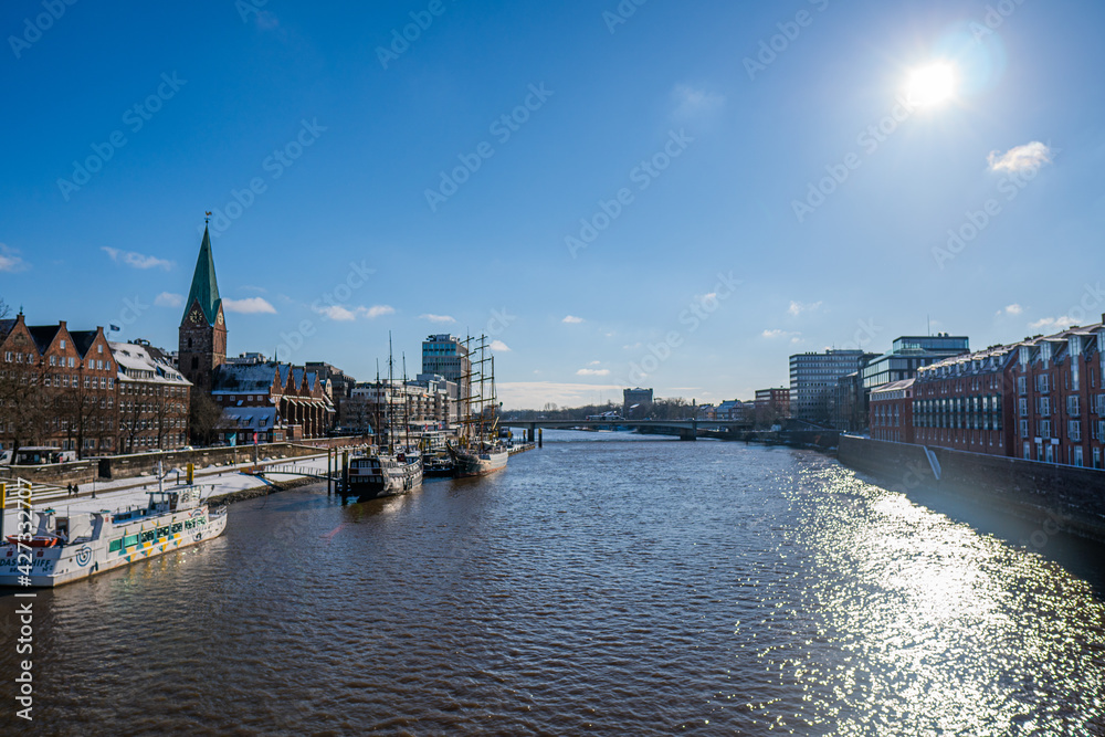 View from footbridge to river weser with some boats in the sunlight in bremen in winter View from footbridge to river weser with some boats in the sunlight in bremen in winter