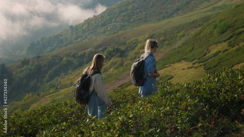 two high school girls is traveling at nature in mountains two high school girls is traveling at nature in mountains