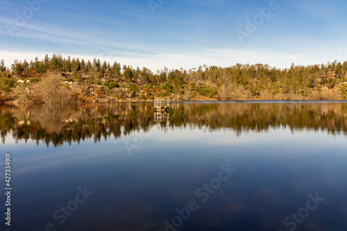beautiful lake landscape, with a blue sky , and vibrant autumn colors reflecting your image in the water mirror, in Viseu, Portugal