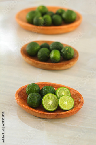 kaffir lime on a coconut wood plate