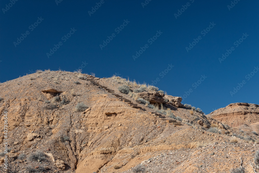 Wood timber stairs up the side of a mountain, Sevilleta National Wildlife Reserve, New Mexico desert, horizontal aspect