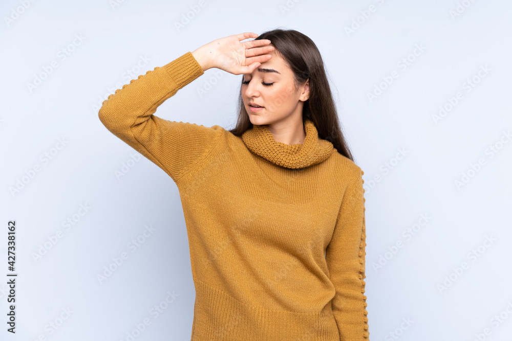 Young caucasian woman isolated on blue background with tired and sick expression Young caucasian woman isolated on blue background with tired and sick expression