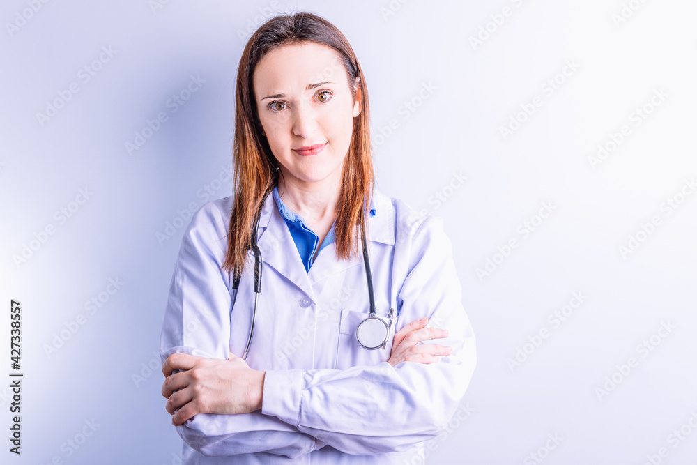 Portrait of young pretty doctor on white background wearing white coat and stethoscope. medicine concept new generation of doctors Portrait of young pretty doctor on white background wearing white coat and stethoscope. medicine concept new generation of doctors