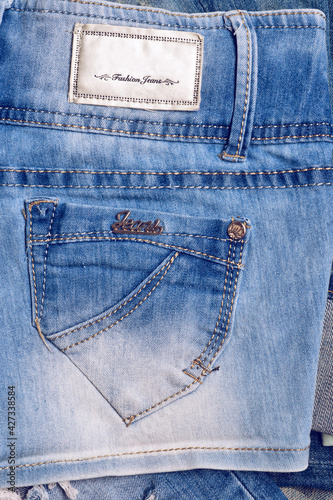 fashion jeans details - back pocket. denim background. studio shot