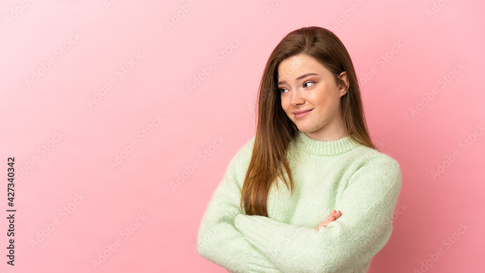 Teenager girl over isolated pink background making doubts gesture while lifting the shoulders Teenager girl over isolated pink background making doubts gesture while lifting the shoulders