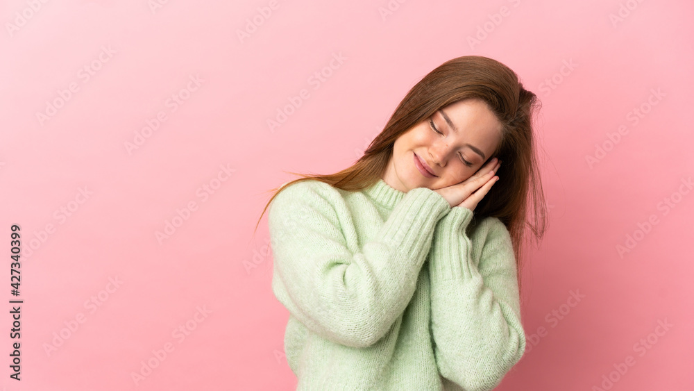 Teenager girl over isolated pink background making sleep gesture in dorable expression