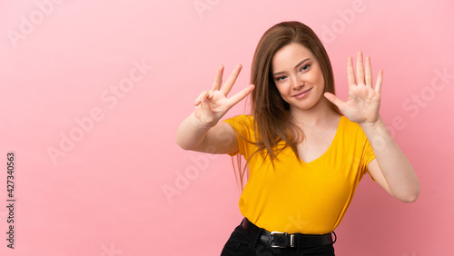Teenager girl over isolated pink background counting eight with fingers