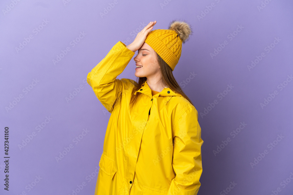 Teenager girl wearing a rainproof coat over isolated purple background has realized something and intending the solution Teenager girl wearing a rainproof coat over isolated purple background has realized something and intending the solution