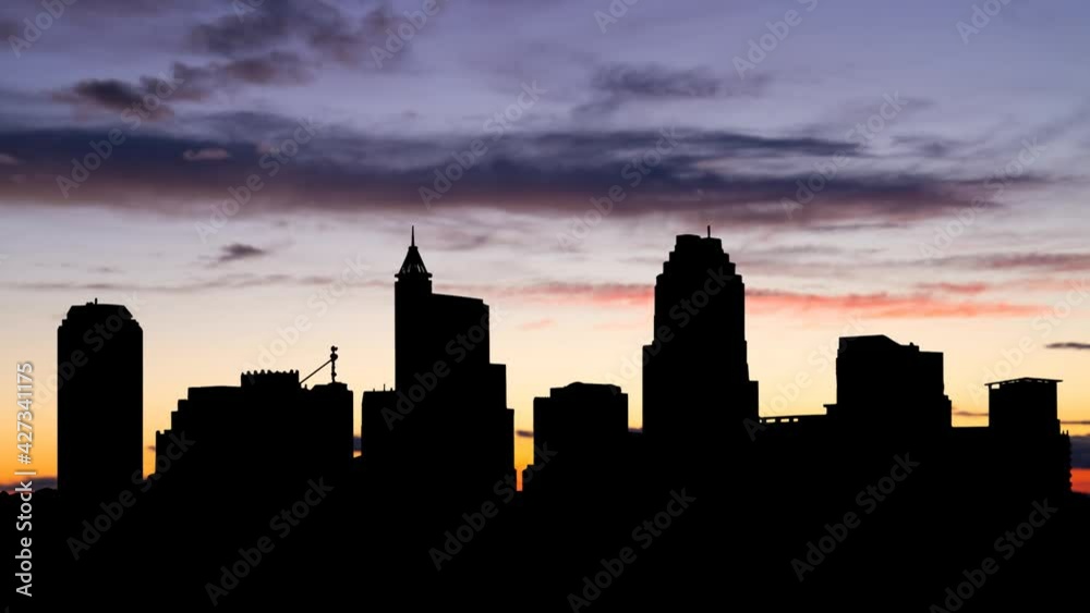Raleigh Skyline, North Carolina, Time Lapse at Twilight with Colourful Sky and Dark Silhouette of Skyscrapers, USA Raleigh Skyline, North Carolina, Time Lapse at Twilight with Colourful Sky and Dark Silhouette of Skyscrapers, USA