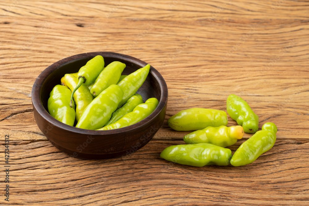 Green cheiro (scent/smell) pepper on a bowl over wooden table Green cheiro (scent/smell) pepper on a bowl over wooden table