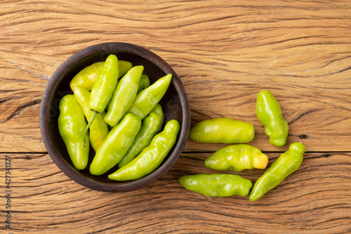 Green cheiro (scent/smell) pepper on a bowl over wooden table photo