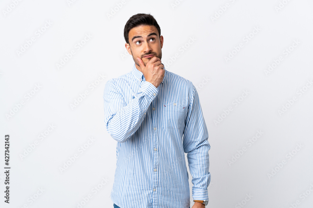 Young handsome man over isolated background having doubts Young handsome man over isolated background having doubts