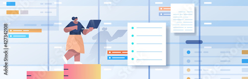 businesswoman working on laptop business planning multitasking time management concept