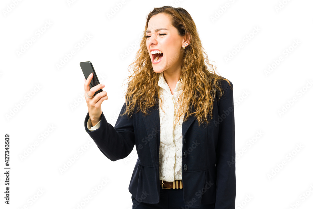 Hispanic woman discussing on the phone with a work colleague Hispanic woman discussing on the phone with a work colleague