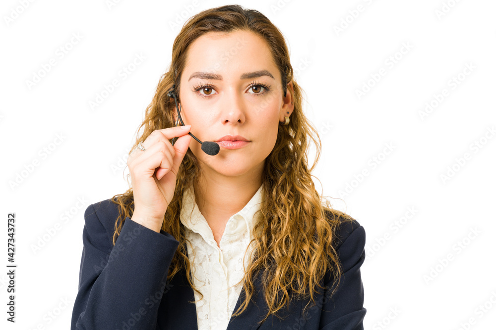Serious attractive woman wearing a headset at work Serious attractive woman wearing a headset at work