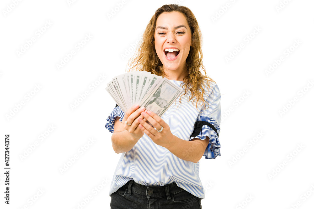 Latin woman celebrating after receiving a lot of cash Latin woman celebrating after receiving a lot of cash
