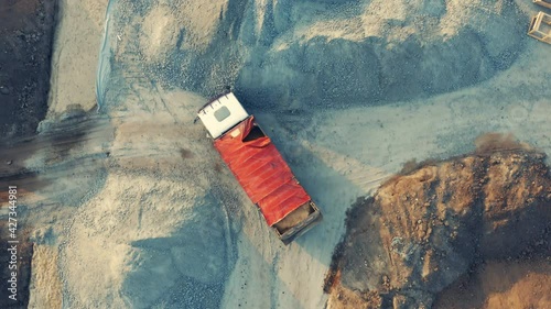 Aerial top down view of a truck maneuvers on a building plot (developable site or constructible surface)