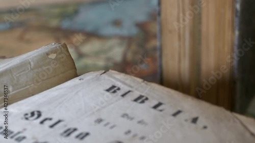 Close shot of Old bible and historical location on Map, tilt up rack focus photo