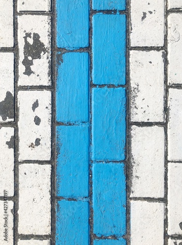 Wallpaper Mural Blue and white tiles pathway cracked painted line between bricks Torontodigital.ca