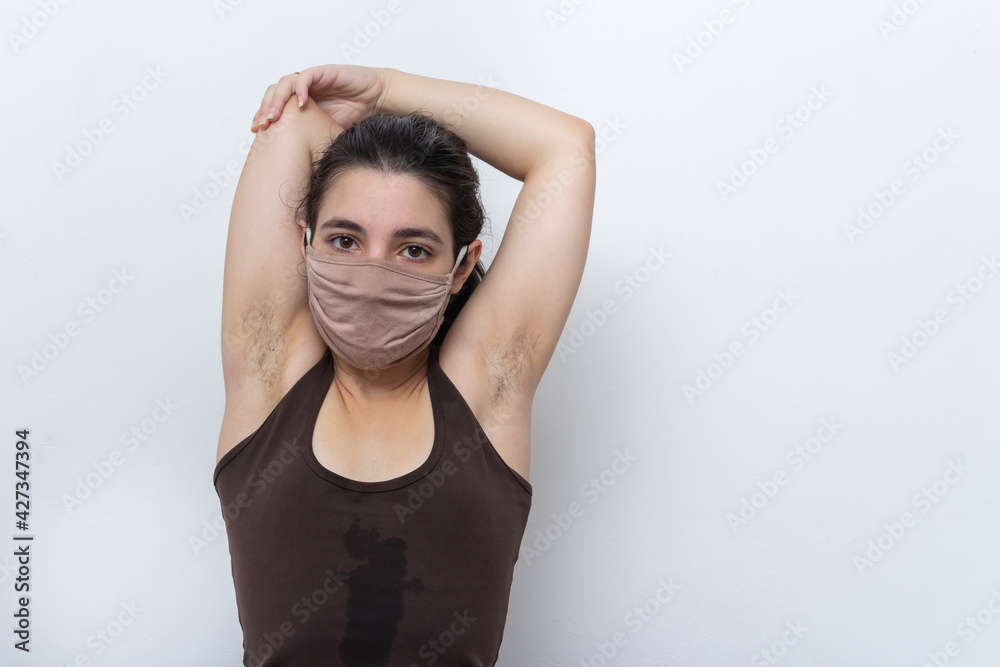 Brown tank top woman on white background with mask tied hair exercising