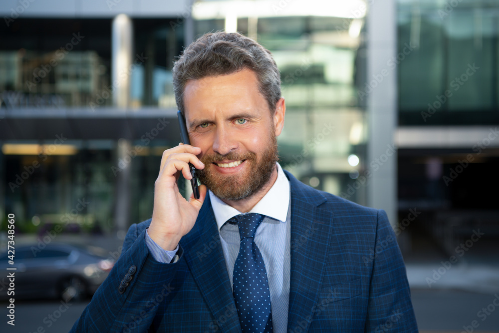 Portrait of smiling businessman outdoors. Closeup of happy mature business man outdoor. Urban man talking on smart phone outside. Portrait of smiling businessman outdoors. Closeup of happy mature business man outdoor. Urban man talking on smart phone outside.