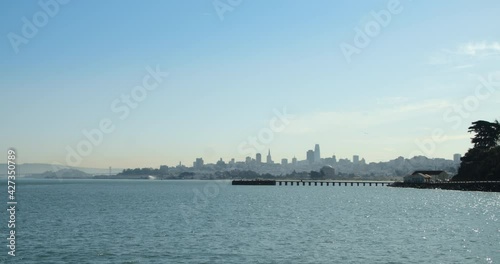 Distant San Francisco Skyline with the Bay in Foreground and Birds Flying Overhead photo