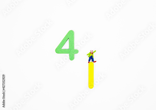 Top view of clown figurine standing on number 1 with number isolated on white background