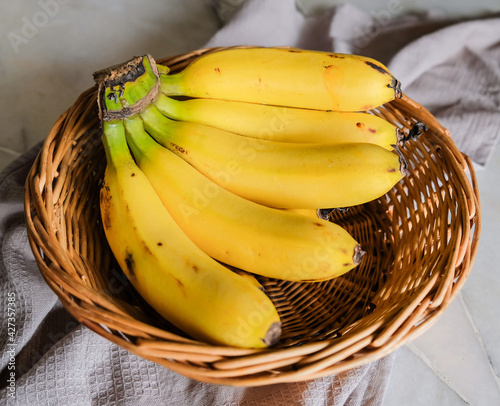 Popular local banana available all year round / Pisang Berangan / Sweet and starchy when ripen with yellow to orange hue flesh with black speckles on its skin, a favorite dessert and in culinary use photo