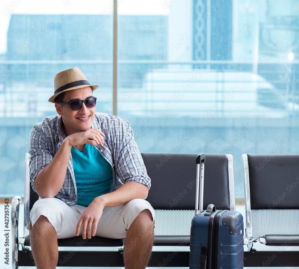 Young man travelling for his summer beach vacation Young man travelling for his summer beach vacation