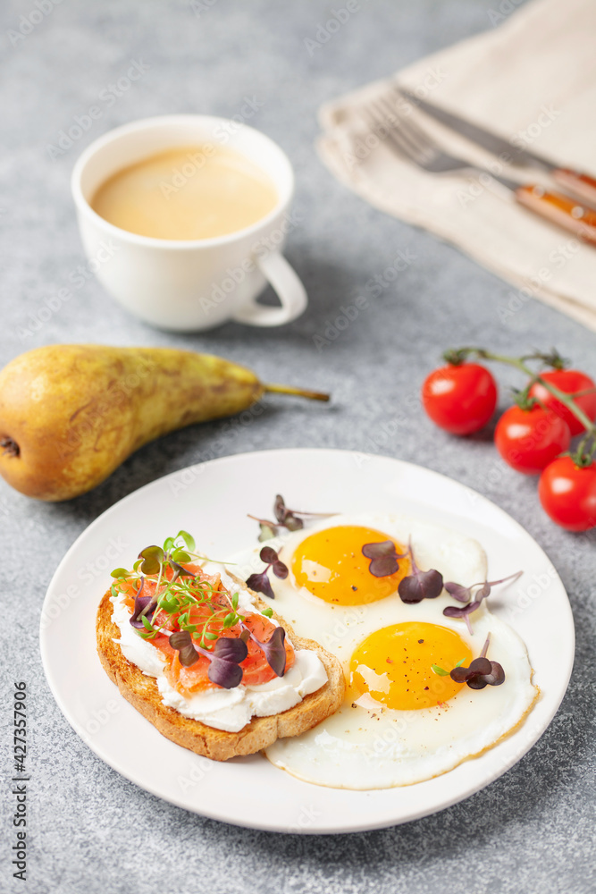 Eggs with microgreens and sandwich with cheese and salmon. Healthy breakfast Eggs with microgreens and sandwich with cheese and salmon. Healthy breakfast